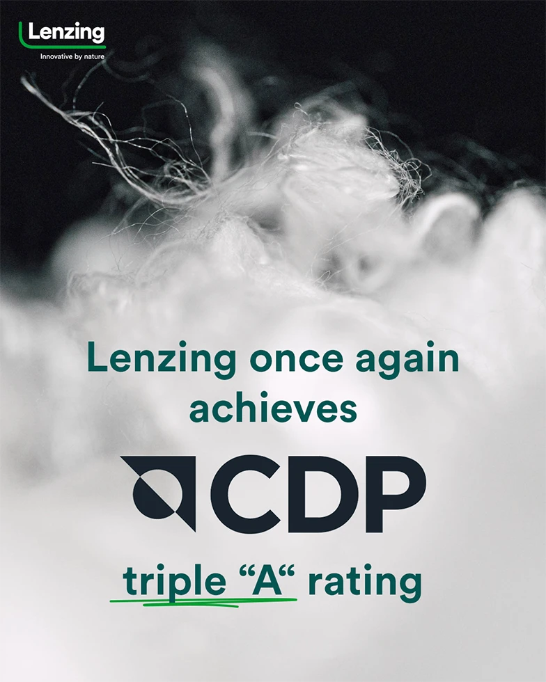 Text: “Lenzing achieves CDP Climate A rating for fourth year in a row” with mass of white fibers in background (Photo)